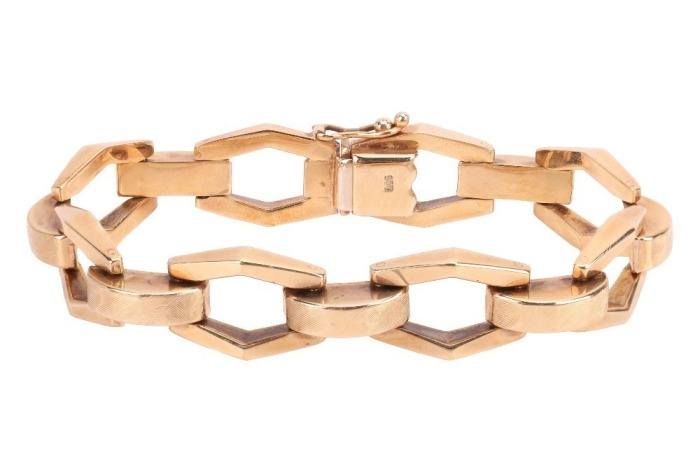 An angular link bracelet, composed of stylised hexagonal openwork links, each connected by a domed rectangular link with Florentine finish, completed with an integral box clasp and additional safety catch, 16.5cm in length, 1.0cm in width, the clasp marke
