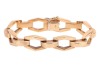 An angular link bracelet, composed of stylised hexagonal openwork links, each connected by a domed rectangular link with Florentine finish, completed with an integral box clasp and additional safety catch, 16.5cm in length, 1.0cm in width, the clasp marke