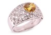 A yellow sapphire and diamond-set dress ring, claw-set with a heart-shaped yellow sapphire, to a diamond-set openwork ring, of lattice design, in white metal marked &lsquo;18K&rsquo; and &lsquo;750&rsquo;, size M; 5.8 grams