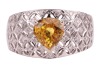 A yellow sapphire and diamond-set dress ring, claw-set with a heart-shaped yellow sapphire, to a diamond-set openwork ring, of lattice design, in white metal marked &lsquo;18K&rsquo; and &lsquo;750&rsquo;, size M; 5.8 grams - 2
