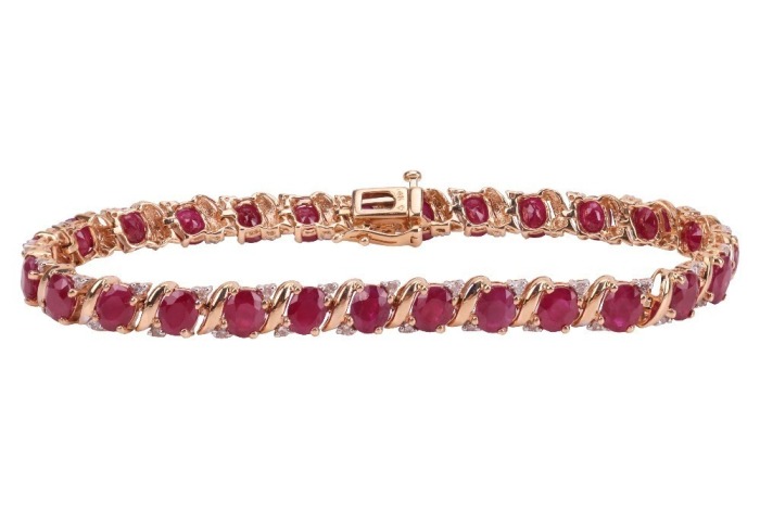 A fracture-filled ruby and diamond-set bracelet, claw-set with fracture-filled rubies and round brilliant diamonds, in a yellow metal mount marked &lsquo;14K&rsquo;, with integrated push bar clasp and safety catch; 12.3 grams
