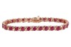 A fracture-filled ruby and diamond-set bracelet, claw-set with fracture-filled rubies and round brilliant diamonds, in a yellow metal mount marked &lsquo;14K&rsquo;, with integrated push bar clasp and safety catch; 12.3 grams