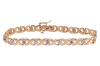 A gem-set floral bracelet, the crossover links with flower motifs, set with round brilliant diamonds and round pink sapphires, in an alternating pattern, to a bi-colour metal mount, with integrated push bar clasp and safety catch, marked &lsquo;14K&rsquo;; 8.0 grams