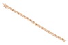 A gem-set floral bracelet, the crossover links with flower motifs, set with round brilliant diamonds and round pink sapphires, in an alternating pattern, to a bi-colour metal mount, with integrated push bar clasp and safety catch, marked &lsquo;14K&rsquo;; 8.0 grams - 3