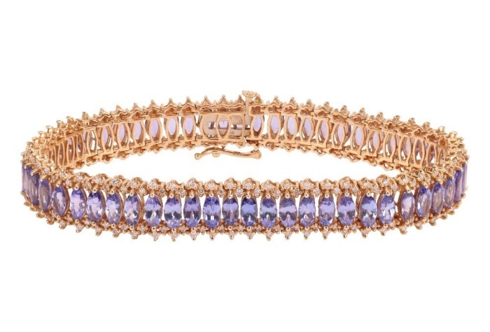 A tanzanite and diamond-set bracelet, by Iliana, composed of a row of marquise-cut tanzanites, claw-set between round brilliant diamonds, in a yellow metal mount marked &lsquo;18K&rsquo;, with integrated push bar clasp and safety catch, measuring approximately 20.5cm
