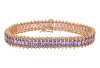 A tanzanite and diamond-set bracelet, by Iliana, composed of a row of marquise-cut tanzanites, claw-set between round brilliant diamonds, in a yellow metal mount marked &lsquo;18K&rsquo;, with integrated push bar clasp and safety catch, measuring approximately 20.5cm