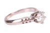 A diamond solitaire ring, comprising a central round brilliant-cut diamond in a six claw setting, with an estimated carat weight of 0.83ct, to tapering shoulders with circular drilled detail, to an 18ct white gold knife-edge band, size N, 4.9 grams. - 3