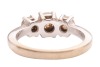 A diamond trilogy ring, with an estimated total diamond weight of 1.00ct, comprising three graduated round brilliant-cut diamonds in claw setting, between tapered shoulders leading to a flat shank, white metal stamped '750', size J, 4.3 grams. Approximate - 4