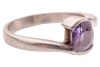 A purple sapphire crossover ring, featuring a cushion-cut purple sapphire of 7.1mm x 6.1mm x 4.5mm, set between bypass shoulders leading to a tapering shank, unmarked white metal testing as platinum, size N&frac12;, 6.4 grams. Accompanied by a Stalwart gem repor - 3