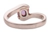A purple sapphire crossover ring, featuring a cushion-cut purple sapphire of 7.1mm x 6.1mm x 4.5mm, set between bypass shoulders leading to a tapering shank, unmarked white metal testing as platinum, size N&frac12;, 6.4 grams. Accompanied by a Stalwart gem repor - 4