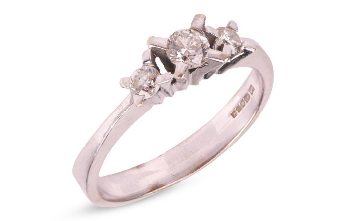 A diamond-set half-hoop ring in 14ct white gold, with an estimated total diamond weight of 0.40ct, comprising three graduated round brilliant-cut diamonds, in claw settings to a tapering shank, Sheffield hallmarks, size R, 3.5 grams.