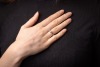 A diamond-set half-hoop ring in 14ct white gold, with an estimated total diamond weight of 0.40ct, comprising three graduated round brilliant-cut diamonds, in claw settings to a tapering shank, Sheffield hallmarks, size R, 3.5 grams. - 2