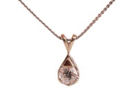 A diamond-set solitaire pendant, claw-set with a round brilliant diamond measuring approximately 4.25mm with an estimated carat weight of 0.28ct, in a teardrop-shaped pendant, to a white metal chain with bolt ring clasp, marked &lsquo;14K&rsquo;, measuring approximat