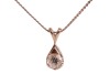 A diamond-set solitaire pendant, claw-set with a round brilliant diamond measuring approximately 4.25mm with an estimated carat weight of 0.28ct, in a teardrop-shaped pendant, to a white metal chain with bolt ring clasp, marked &lsquo;14K&rsquo;, measuring approximat