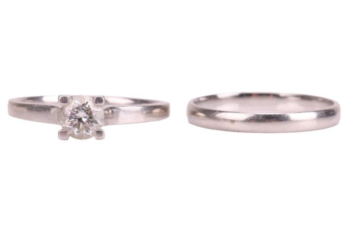 A diamond solitaire ring and a band ring, the solitaire featuring a claw-set round brilliant-cut diamond of estimated 0.83ct, to a plain platinum ring shank, size T, 5.24 grams, together with a plain platinum band ring, size T &frac12;, 3.6 grams. Together with 