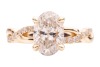 A laboratory-grown diamond solitaire ring, centred with an oval-cut diamond of 1.51ct, between twisted diamond-set shoulders leading to shank, in unmarked yellow metal surface testing as 14ct, size K, 4.3 grams. Diamond has been inscribed with an IGI repo - 2