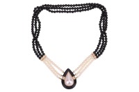 A Mab&eacute; pearl and onyx necklace, comprising three rows of cultured pearls and round onyx beads, bar spacers set with rows of diamond accents, the teardrop-shaped centre piece functioning as a box clasp, centred with a mab&eacute; pearl within a conforming hardsto