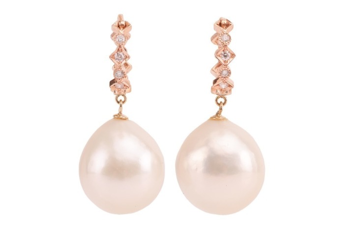 A pair of cultured South Sea pearl drop earrings; the pearls of rounded teardrop shape, with ivory colour and silver-pink lustre, suspended from hoops of pink metal surface testing as 14ct, measuring 13mm in diameter, featuring diamond accents of approxim