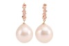 A pair of cultured South Sea pearl drop earrings; the pearls of rounded teardrop shape, with ivory colour and silver-pink lustre, suspended from hoops of pink metal surface testing as 14ct, measuring 13mm in diameter, featuring diamond accents of approxim