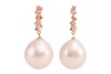 A pair of cultured South Sea pearl drop earrings; the pearls of rounded teardrop shape, with ivory colour and silver-pink lustre, suspended from hoops of pink metal surface testing as 14ct, measuring 13mm in diameter, featuring diamond accents of approxim - 2