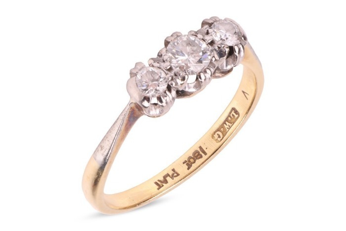 A diamond-set three-stone ring, claw-set with three round brilliant diamonds, with an estimated total diamond carat weight of 0.43ct, to a bi-colour metal mount marked &lsquo;18ct&rsquo; and &lsquo;Plat&rsquo;, size N1/2; 2.8 grams