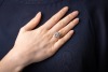 A diamond cluster ring, with an estimated total diamond weight of 2.00ct, the rhombic cluster is composed of a marquise-cut diamond and twelve round brilliant-cut diamonds, set in a wire basket and tapered shoulders, in white metal surface testing as 18ct - 5