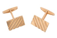 A pair of cufflinks of rectangular form with striated design, the panels fitted with toggle swivels, yellow metal marked '750', panel measures 2.0 x 1.3 cm, total weight of items 16.73 grams.