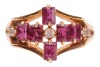A ruby and diamond dress ring, six rectangular table-cut rubies and three single-cut diamonds composing a cruciform, between bifurcated shoulders leading to an angular shank, yellow metal stamped '585', size L, 2.8 grams. - 3