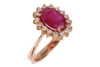 A ruby and diamond-set cluster ring, centred with an oval mixed-cut ruby measuring approximately 10.2mm x 7.2mm, surrounded by sixteen round brilliant diamonds, claw-set in a yellow metal mount marked &lsquo;750&rsquo;, size S; 5.9 grams