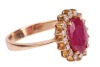 A ruby and diamond-set cluster ring, centred with an oval mixed-cut ruby measuring approximately 10.2mm x 7.2mm, surrounded by sixteen round brilliant diamonds, claw-set in a yellow metal mount marked &lsquo;750&rsquo;, size S; 5.9 grams - 4