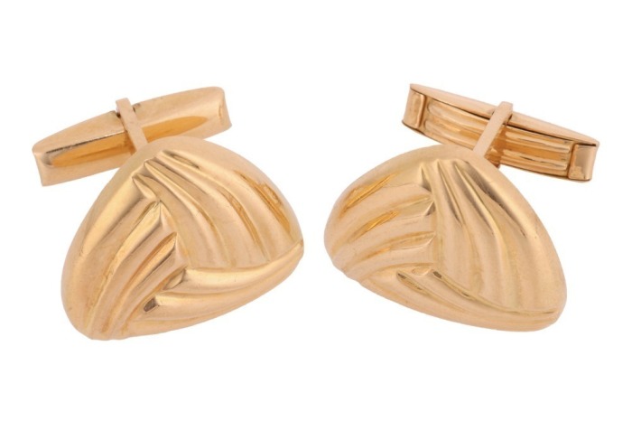 A pair of triangular cufflinks of reeded design, fitted with swivel backs, yellow metal marked '750', cufflink motif measures 2.4 cm across, total weight of item 46.7 grams.