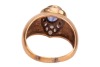 A sapphire and diamond dress ring, the egg-shaped ring head collet-set with an oval-cut sapphire of 7.0 x 5.5 x 4.2 mm, in surround bead-set with round brilliant-cut diamonds, leading to tapering shank in yellow metal marked '750', ring head 1.5 x 1.1 cm, - 4