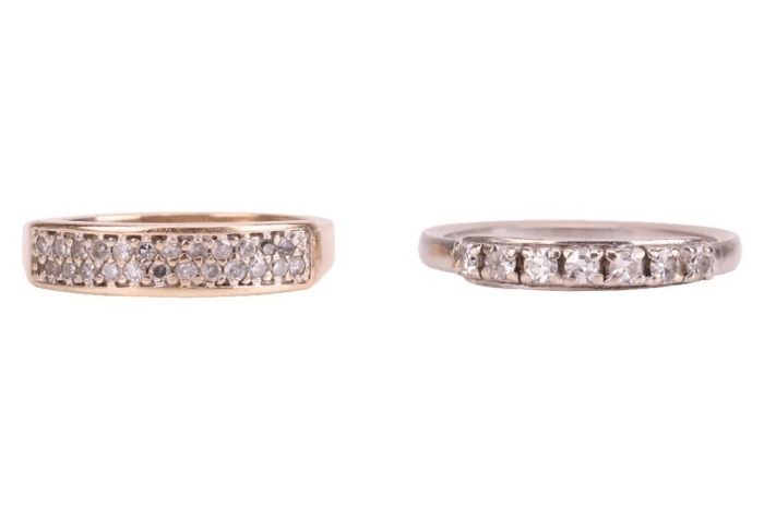 Two rings; comprising a diamond-set seven-stone ring, in a white metal mount marked &lsquo;750&rsquo;, size N, together with a diamond-set dress ring, grain-set with round brilliant diamonds in a 9ct yellow gold mount, size L; 4.8 grams (2)