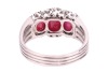 A ruby cabochon and diamond dress ring, comprising three graduated oval ruby cabochons, embellished with single-cut diamonds, to a shank composed of four knife-edged bands, in white metal stamped '750', size R&frac12;, 7.5 grams. - 4