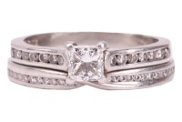 A single stone diamond ring, the princess-cut diamond claw-mounted in platinum above channel-set diamond shoulders, accompanied by a GIA report stating that the diamond is E, VS1 and 0.41 carats; together with a platinum and diamond set crossover wedding 