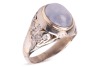 A star sapphire and diamond-set ring, centrally set with an oval sapphire cabochon, displaying asterism, in a bezel setting leading to diamond-set shoulders, in an unmarked white metal mount, surface tested as 9ct, size O; 6.7 grams Please note: Unless ot