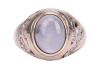 A star sapphire and diamond-set ring, centrally set with an oval sapphire cabochon, displaying asterism, in a bezel setting leading to diamond-set shoulders, in an unmarked white metal mount, surface tested as 9ct, size O; 6.7 grams Please note: Unless ot - 2