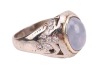 A star sapphire and diamond-set ring, centrally set with an oval sapphire cabochon, displaying asterism, in a bezel setting leading to diamond-set shoulders, in an unmarked white metal mount, surface tested as 9ct, size O; 6.7 grams Please note: Unless ot - 3