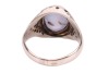 A star sapphire and diamond-set ring, centrally set with an oval sapphire cabochon, displaying asterism, in a bezel setting leading to diamond-set shoulders, in an unmarked white metal mount, surface tested as 9ct, size O; 6.7 grams Please note: Unless ot - 4