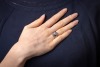 A star sapphire and diamond-set ring, centrally set with an oval sapphire cabochon, displaying asterism, in a bezel setting leading to diamond-set shoulders, in an unmarked white metal mount, surface tested as 9ct, size O; 6.7 grams Please note: Unless ot - 5