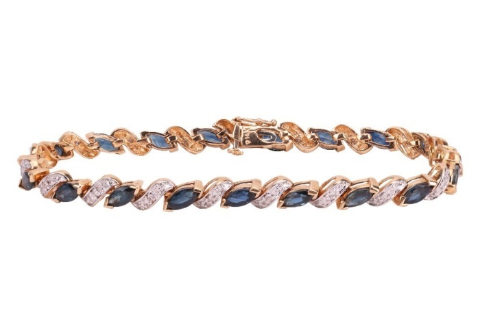 A sapphire and diamond-set bracelet, with marquise-cut sapphires, set at an angle, interspersed by diamond-set links, in a yellow metal mount, with integrated clasp and safety catch, marked &lsquo;14K&rsquo;, measuring approximately 18.9cm; 12.0 grams