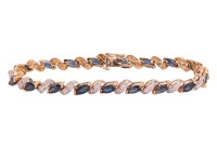 A sapphire and diamond-set bracelet, with marquise-cut sapphires, set at an angle, interspersed by diamond-set links, in a yellow metal mount, with integrated clasp and safety catch, marked &lsquo;14K&rsquo;, measuring approximately 18.9cm; 12.0 grams