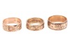 Three band rings; The first a 9ct yellow gold band ring, with floral engraving, size R, the band 8.2mm wide, 5.19 grams; The second a diamond-set band ring, featuring rose and scrolled details, the rose motifs interspersed with a round brilliant-cut diamo - 2