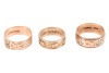 Three band rings; The first a 9ct yellow gold band ring, with floral engraving, size R, the band 8.2mm wide, 5.19 grams; The second a diamond-set band ring, featuring rose and scrolled details, the rose motifs interspersed with a round brilliant-cut diamo - 3