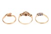Three rings; comprising a diamond-set floral cluster ring, in a bi-colour metal mount marked &lsquo;18ct&rsquo;, size O1/2, a diamond-set three-stone ring, in a bi-colour metal mount marked &lsquo;18ct&rsquo;, size N, and a diamond-set crossover ring in a yellow metal mount mark - 2