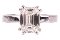 A single stone emerald-cut diamond ring, the diamond measuring approximately 8.8 x 6.6 x 4.6mm, in double four claw corner mounts, above a plain angled shank; Inscribed to the inside of the band 2.55 as stated weight and '750', size K, 4.7 grams. Please n