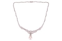 A pearl and diamond necklace in 18ct white gold, of undulating design, featuring a large teardrop-shaped cultured pearl of 16.3 x 13.4 mm, with a diamond-set cap of foliate design, articulated centrepiece attached to segments of bar links and diamond spac