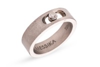 Messika - a diamond-set kinetic ring in titanium, collet-set with a round brilliant-cut diamond with an estimated weight of 0.05ct, to a brush-finished flat band with a sliding aperture, signed and numbered, marked 'titanium', size P (EU size 56), 3.0 gra