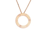 Cartier - a 'Love' pendant on chain, set with three brilliant-cut diamond accents, the annulet pendant engraved with screw motifs, signed and numbered, pink metal marked 'Au750', 2.5 cm wide, on a 42.0 cm fine trace link chain, 12.7 grams. With travel pou