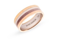 Boucheron - 'My First Four' quatre ring, the polished flat band of tri-coloured metal with a segment of PVD coating, signed and numbered, Swiss assay marks for 18ct, size P (EU size 56), 5.3 grams.